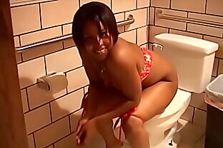 Young sexy chick with olive skin pissing in the toilet, and her boyfriend films