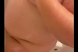 Pissing on big tits and watching her wash off