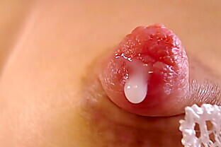Extreme close up of hard nipples dripping milk