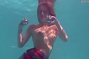 Redhead b. Nikita Vodorezova gets naked fast underwater