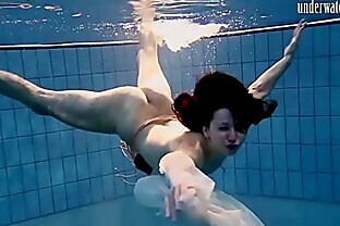 Dark haired teen Andrea floating with hottest ass